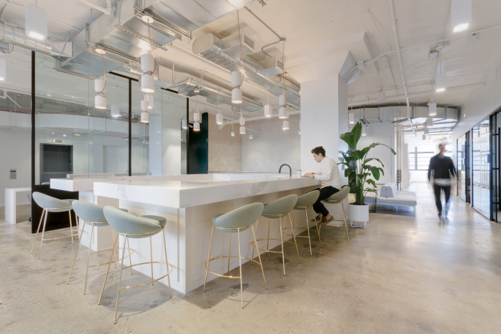 A countertop with stools in the Daily Harvest office.