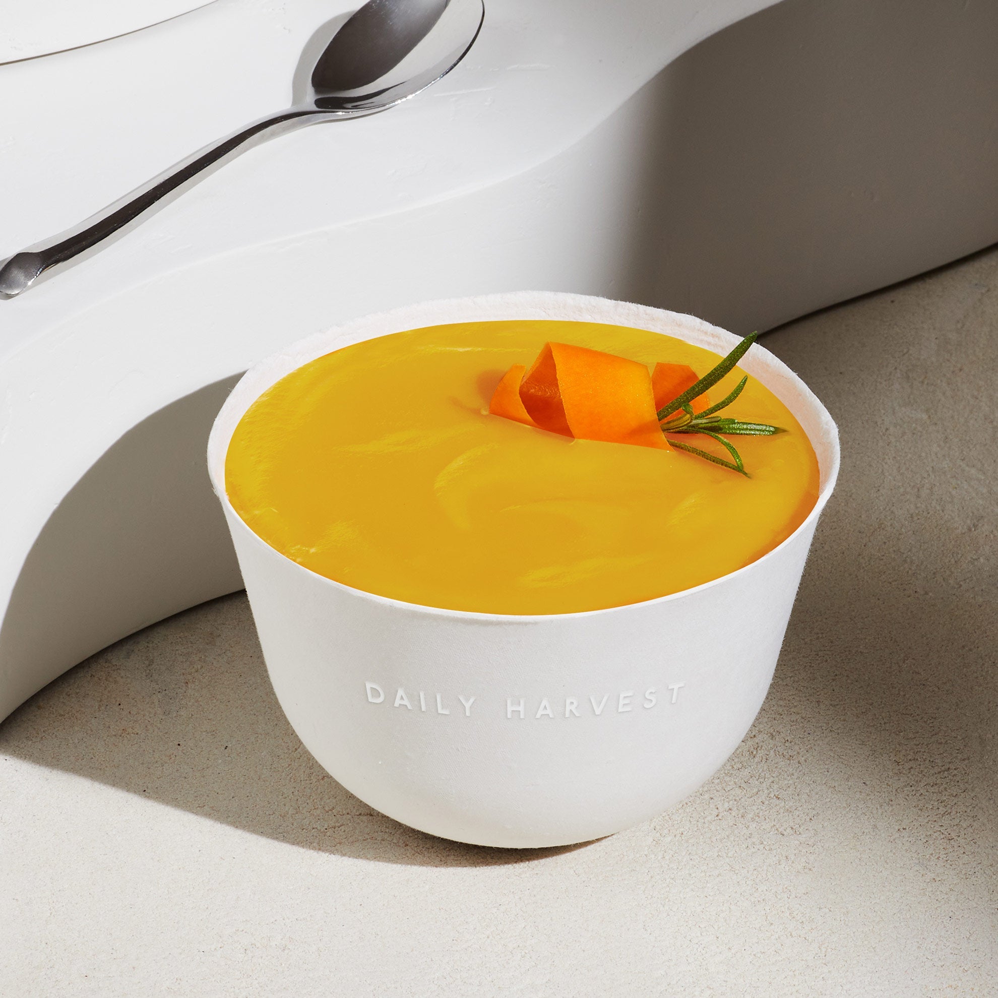 Image of Daily Harvest Butternut Squash + Rosemary Soup prepared in a bowl with garnish.