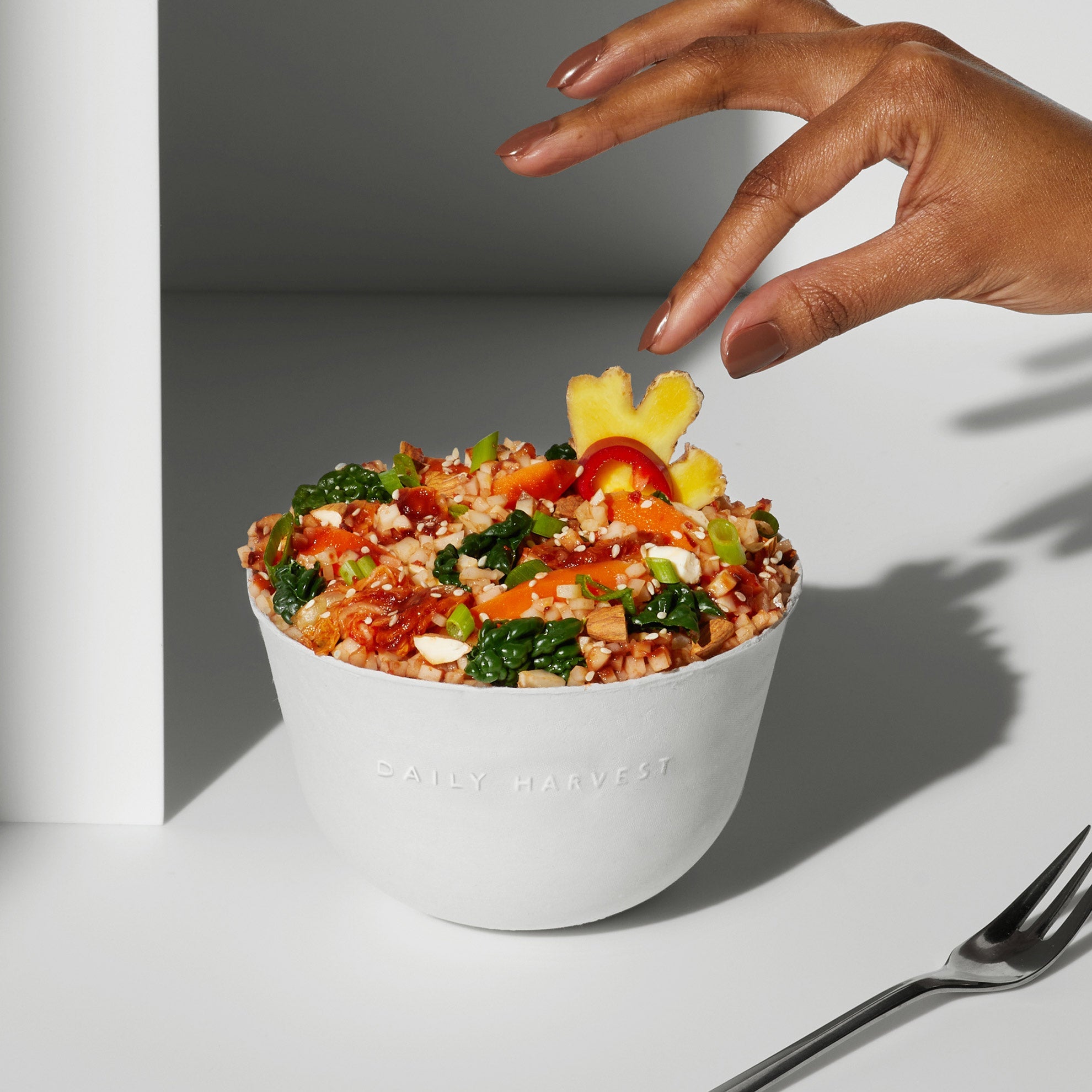 Lifestyle image of Daily Harvest Cauliflower Rice + Kimchi Harvest Bowl prepared in a bowl.